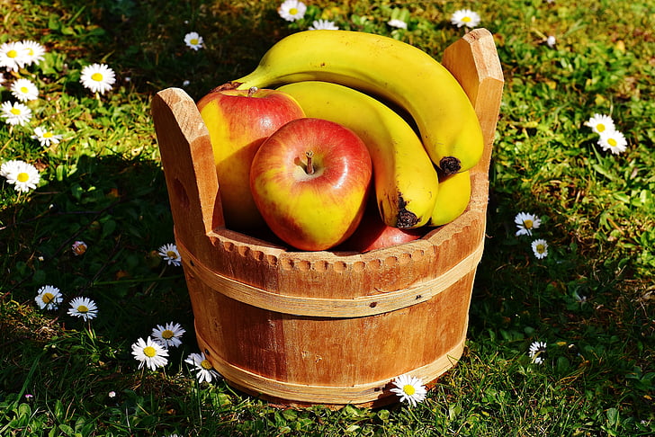 Royalty-Free photo: Banana and apple fruit in barrel at daytime ...